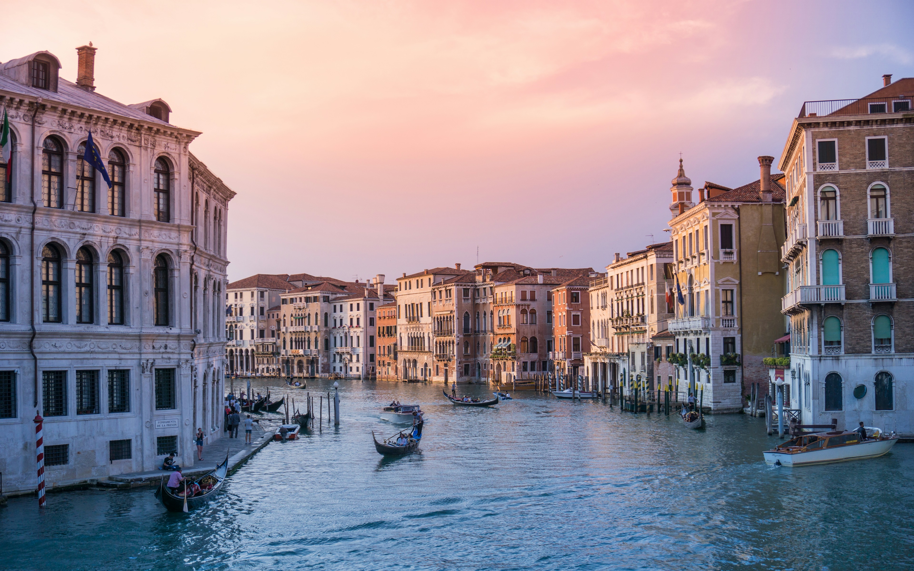 Venice Grand Canal Gondola Ride - St. Mark Basilica Byzantine domes and Piazza San Marco illuminated at twilight Venice