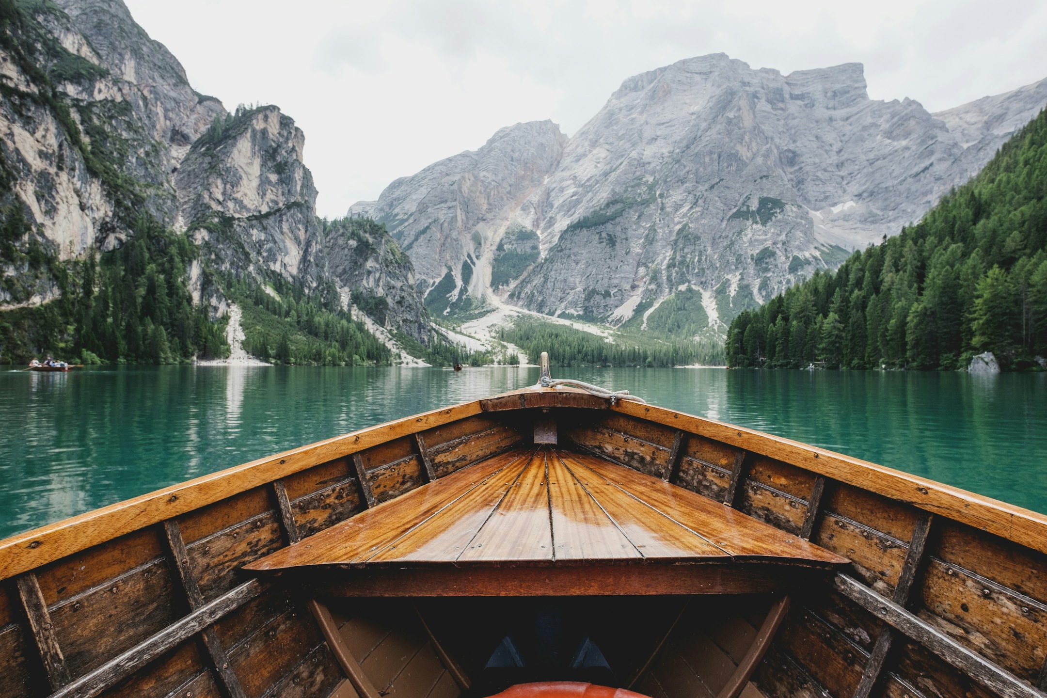 Lake Como Private Boat Tour - Vertical POV perspective from wooden boat cruising turquoise waters towards Alpine peaks